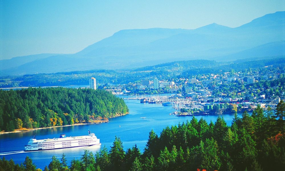 Photo of Nanamio, BC in the background with a ferry in foreground 