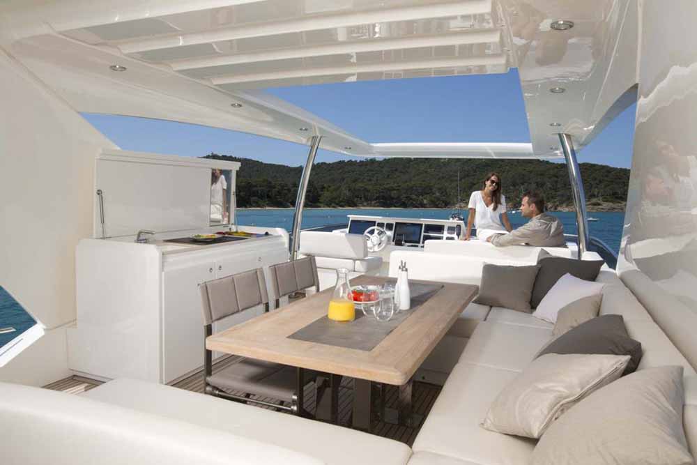 Photo of Prestige 750 flybridge with two people enjoying breakfast