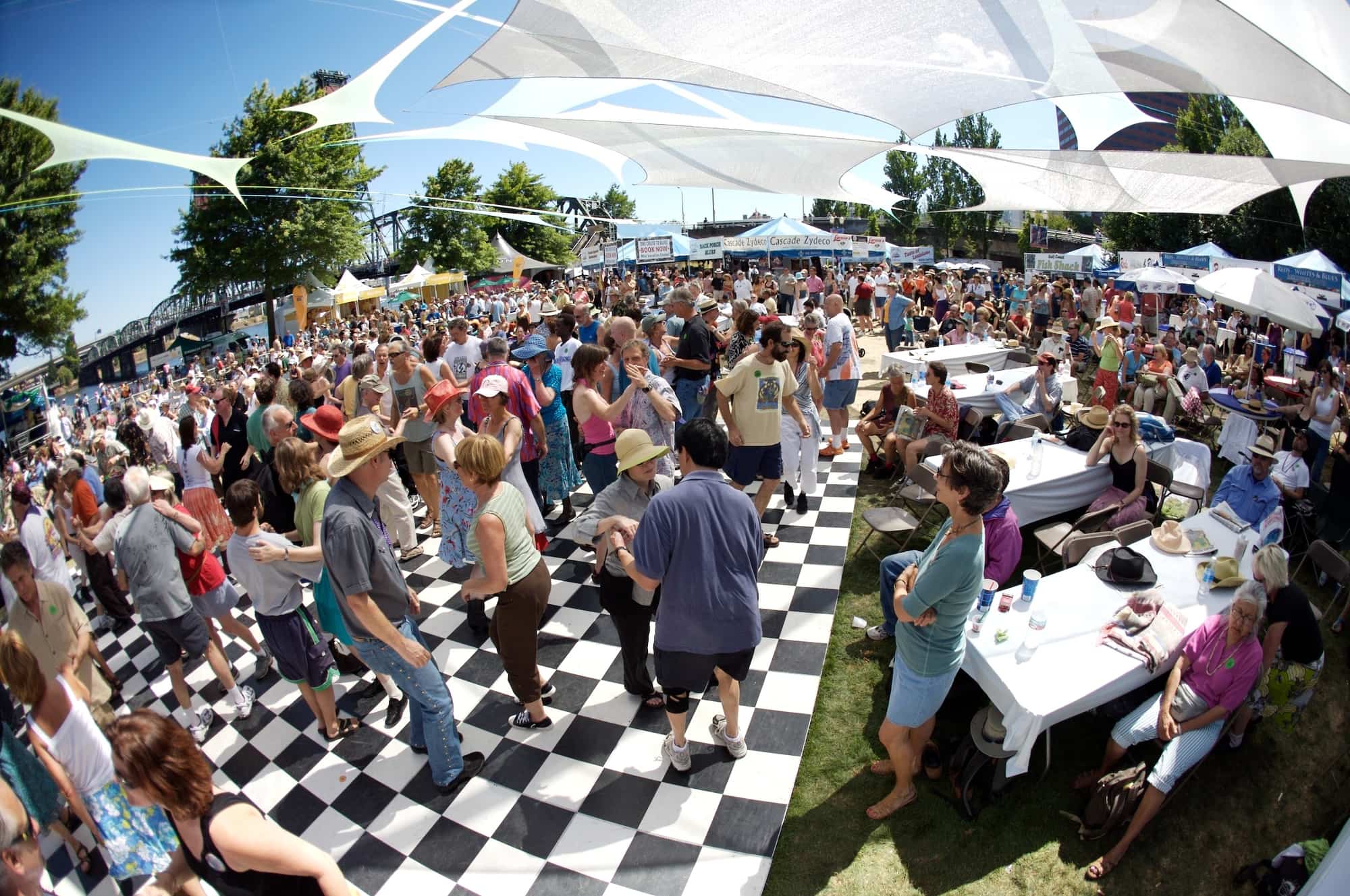 People celebrating under a tent at Blues Fest