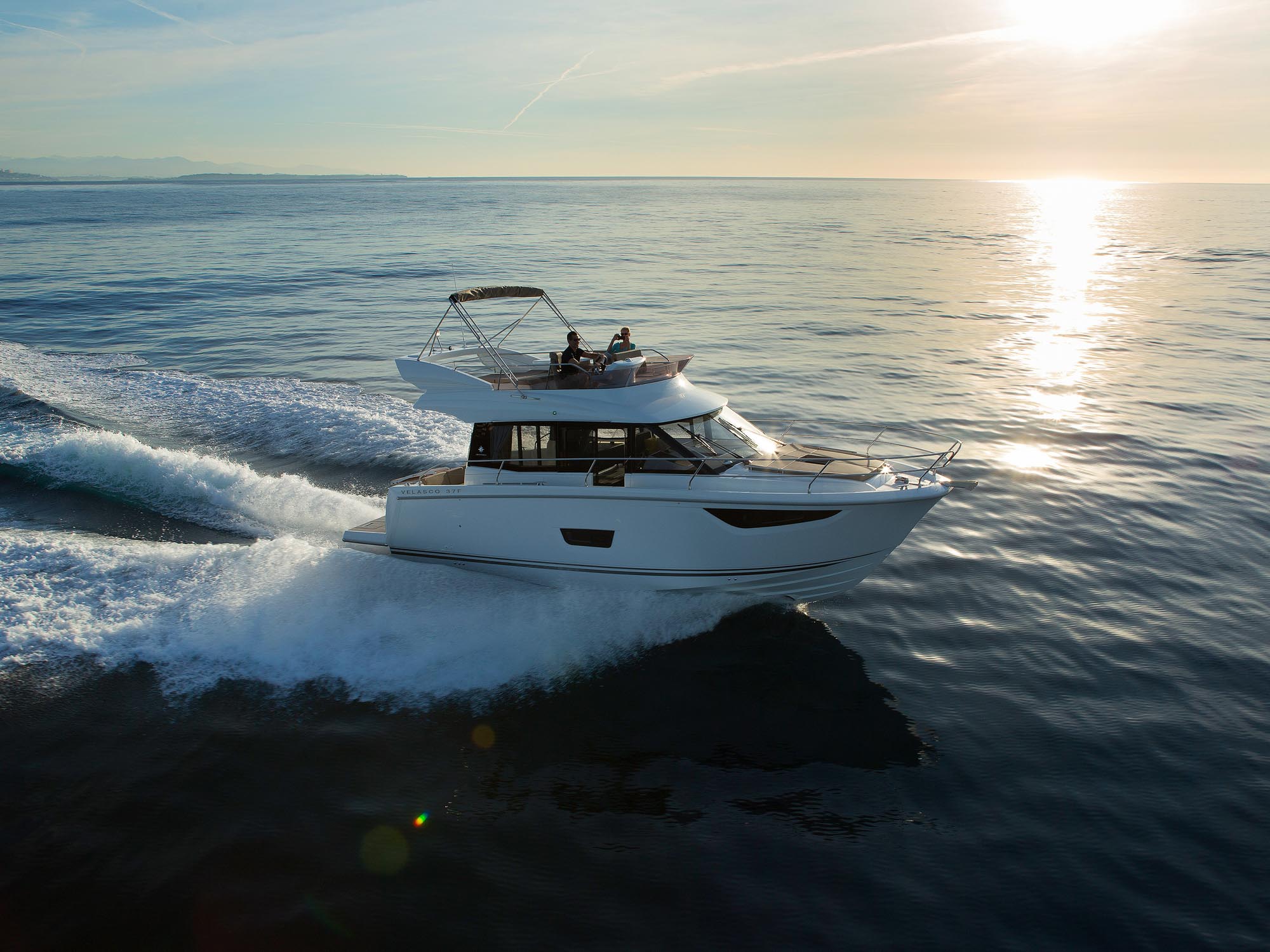 Jeanneau Velasco 37F cruising in the ocean at sunset