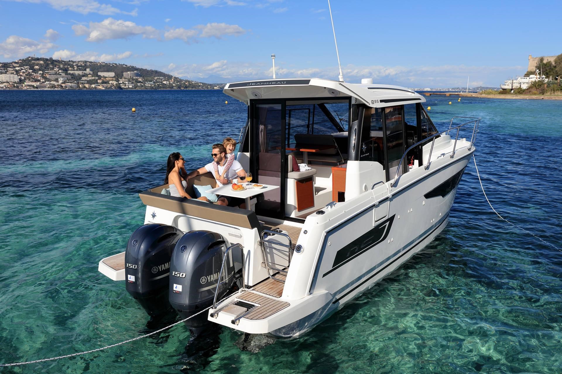 People relaxing on the Jeanneau NC 895 out on the water on a sunny day