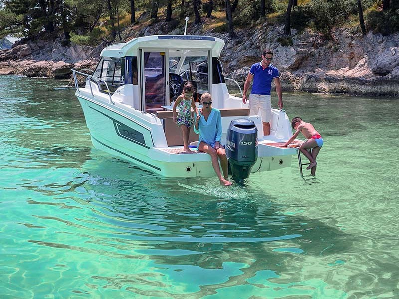 Photo of the Jeanneau NC 795 in a bay with clear water 