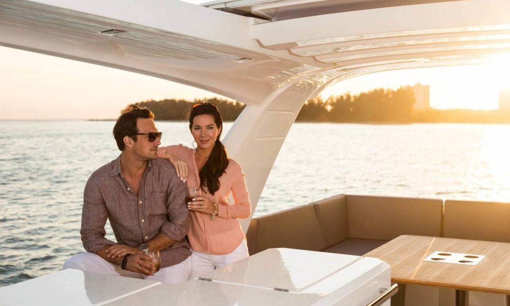 Couple on the flybridge of the Prestige 630 at sunset