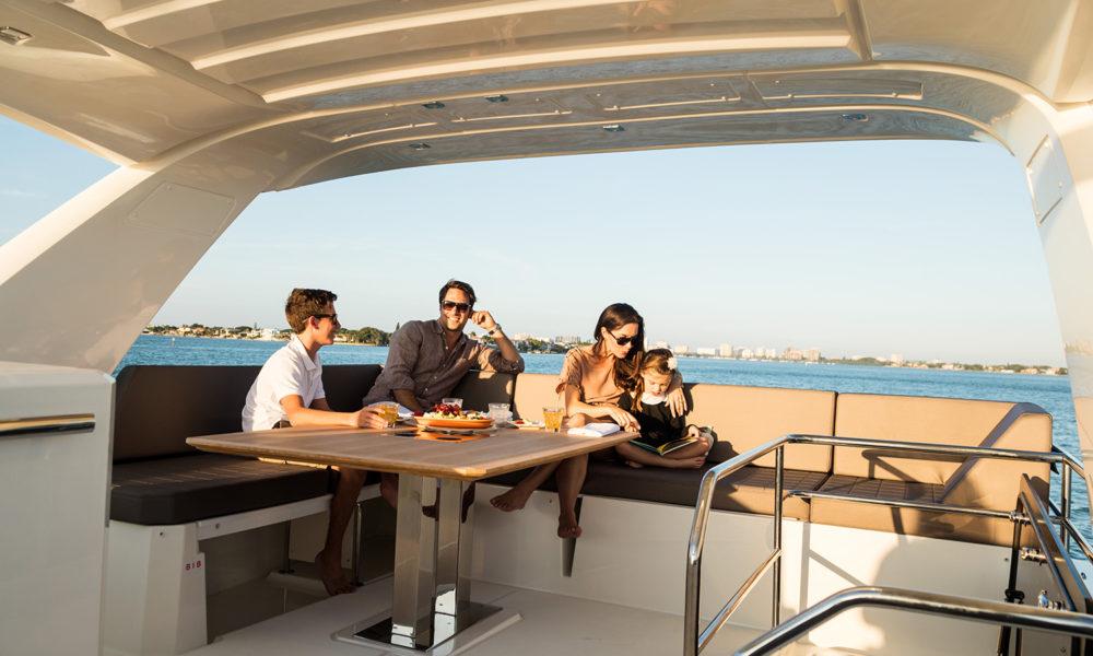 People relaxing on the flybridge of the Prestige 630