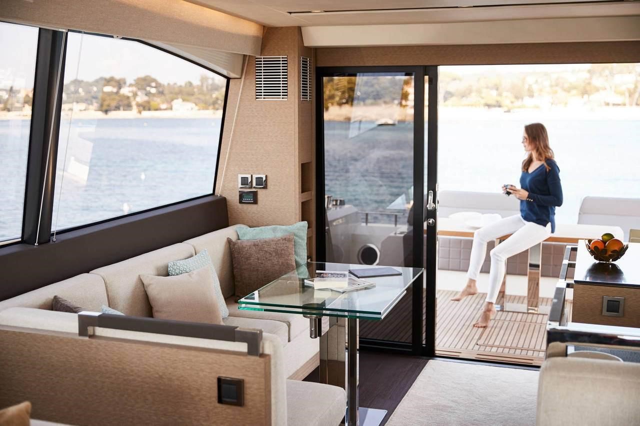 Woman sitting on the cockpit table of the Prestige 680 yacht