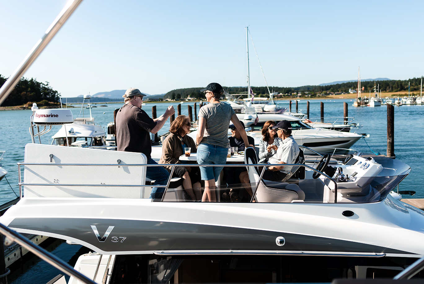 People socializing on flybridge of a Jeanneau 37 Velasco 