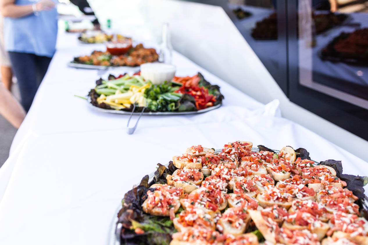 Food and appetizers on trays on white tablecloth 