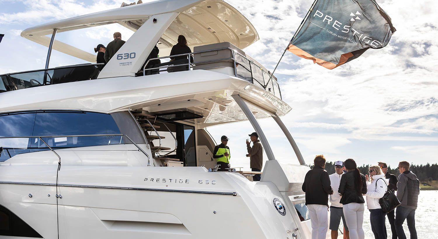 People gathered around a Prestige Yachts 630