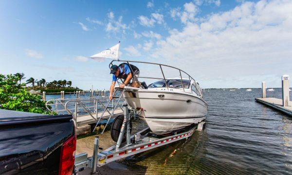 Cutwater 24 on a trailer backed into the water at a boat ramp