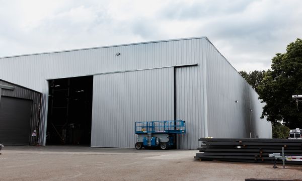 Metal building with boats inside 