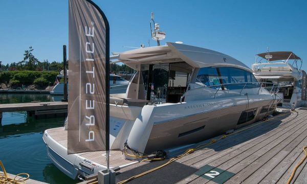 Prestige Yachts 500S tied up at dock at Roche Harbor with Prestige flag on dock