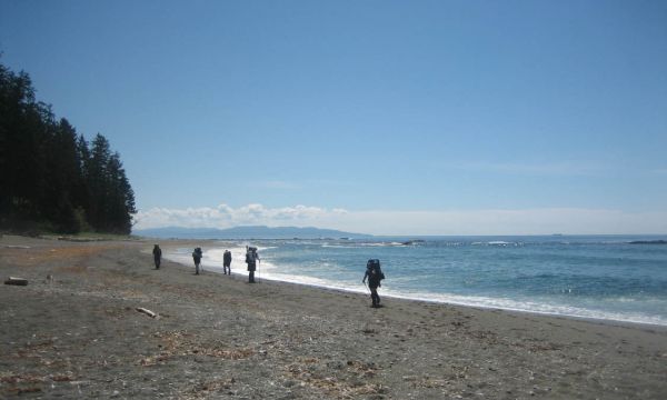 People walking on the beach of the west coast of Vancouver Island in British Columbia