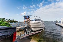 Cutwater 24 on a trailer backed into the water at a boat ramp